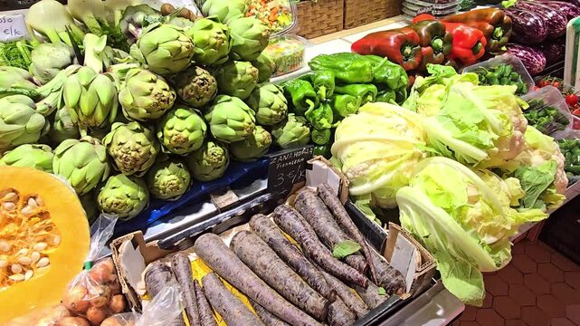 Close up shot of assorted green vegetables and salads on a market stand, highlighting freshness, vivid color and natural texture, showing healthy organic produce in a lively outdoor food market enviro