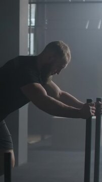 Powerful Gym Workout. Heavy Sled Pushing Performed By Athlete Amidst Gritty Resistance Training Ambience