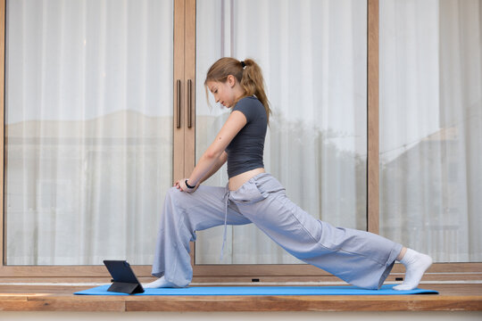 Caucasian woman engaged in a yoga session in a living room
