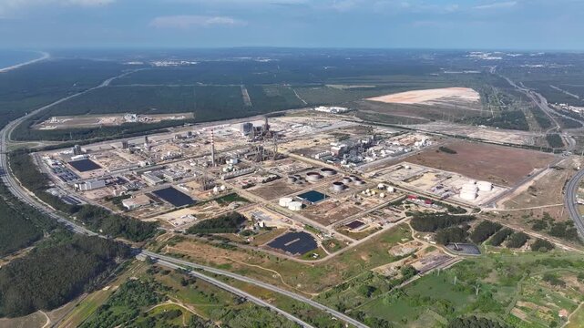 Exploring the vast energy infrastructure of a modern oil refinery under bright daylight