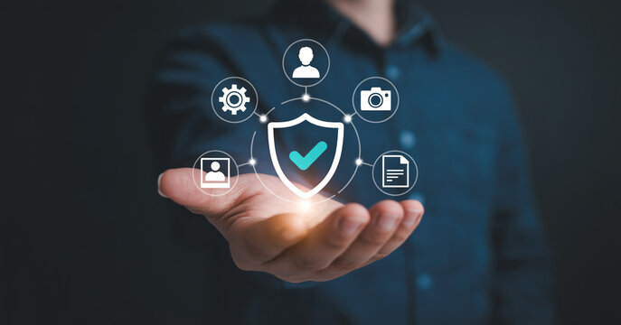 Man holding shield icon with checkmark symbolizing data security and protection digital privacy online safety and cyber defense concept.