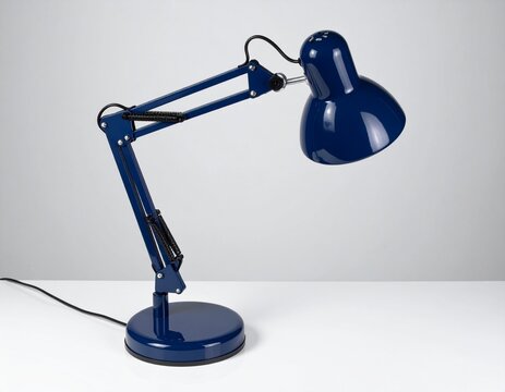 The sophisticated navy blue and chrome desk lamp dimmer knob stands isolated on a minimalist light surface