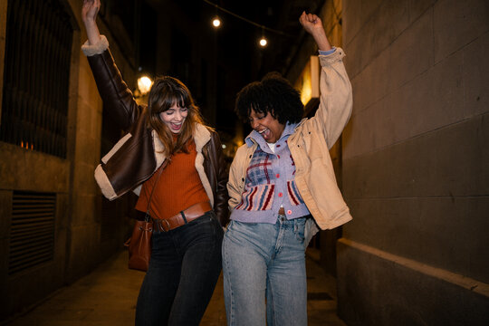 Friendship celebration with dancing in city street at night