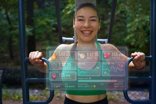 Smiling athlete exercising outdoors with hologram dashboard