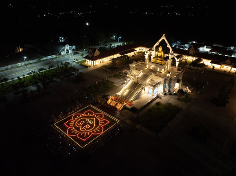 Lopburi, Thailand, April 12, 2025, Puttha Sathan Lopburi Sri Suvarnabhumi - Drone view of illuminated Buddhist temple ceremony in Lopburi