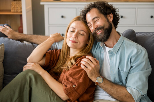 Couple enjoying a relaxed evening together on a couch indoors