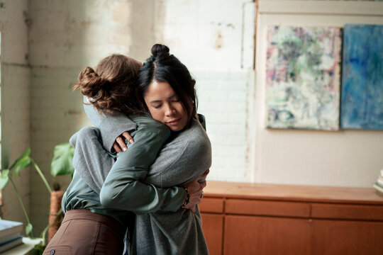 Women embracing each other at art studio