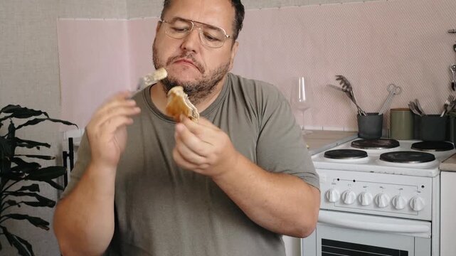 A man eats a triangular pie, samsa or echpochmak in a cafe
