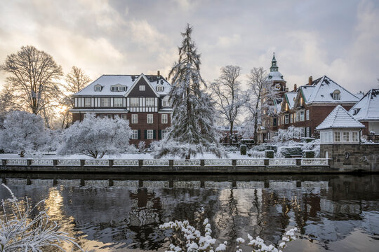 Snowy St. Johannis monastery by Alster river in Hamburg at sunset
