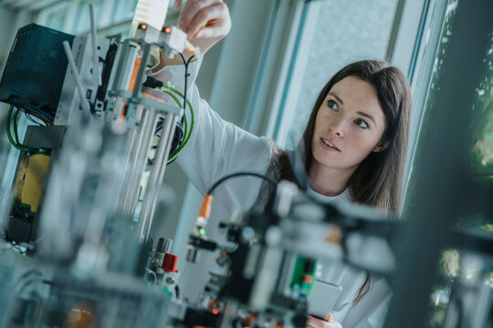 Scientist adjusting sorting machine in laboratory during research