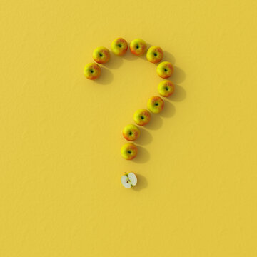 Question mark shaped apple arrangement on yellow background