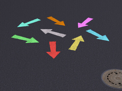 Colorful arrows pointing in different directions on asphalt