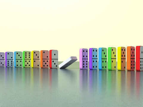 White domino falling out of line in a colorful row