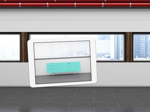 Augmented reality app on tablet showing 3d sideboard in empty loft