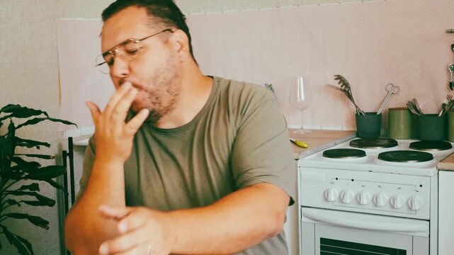 A man eats a triangular pie, samsa or echpochmak in a cafe
