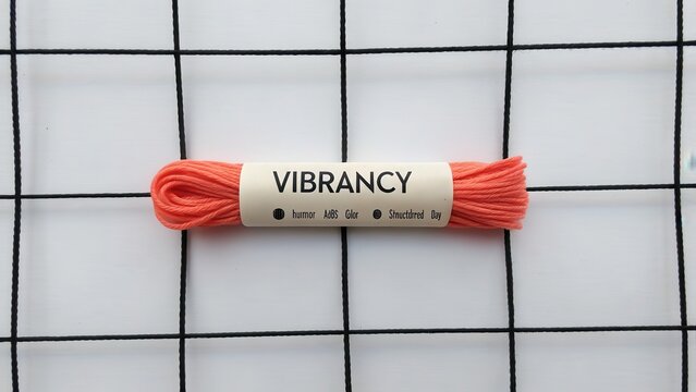 Bright Coral Thread on Grid Background
