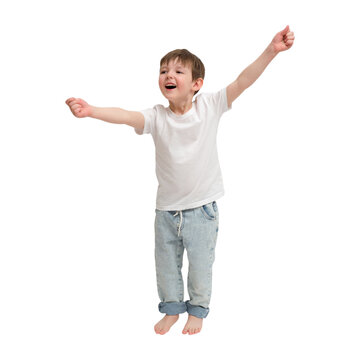 Child boy jumping with happiness on transparent background. Excited kid in white t-shirt and jeans expressing joy and success. Energetic young male celebrating achievement. A kid aged 4 years