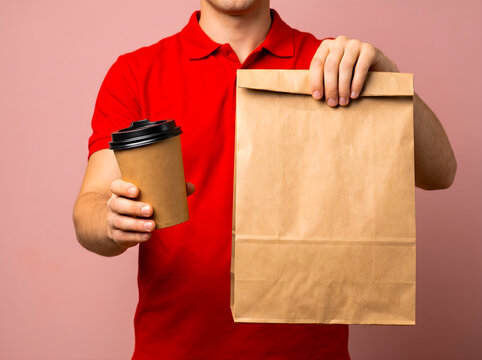 Delivery person holding takeaway coffee and food bag food bag mockup