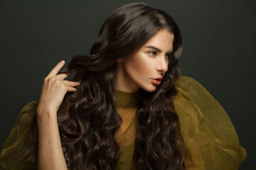 Fototapeta premium Fashion portrait of woman hair. Beautiful model with long curly hairstyle posing