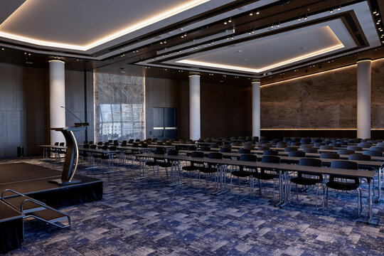 Spacious modern conference hall with rows of tables and chairs, presentation podium, and elegant ambient lighting
