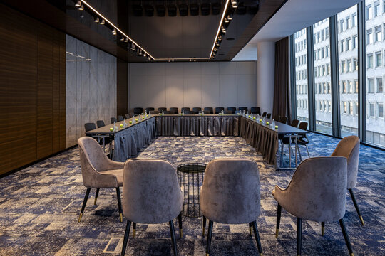 Large conference hall interior with rows of chairs for presentations