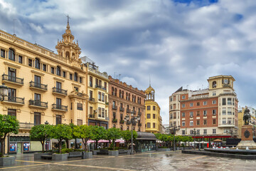 Obraz premium Plaza de las Tendillas in Cordoba, Spain, wide angle view. Urban square with historic buildings under cloudy sky.