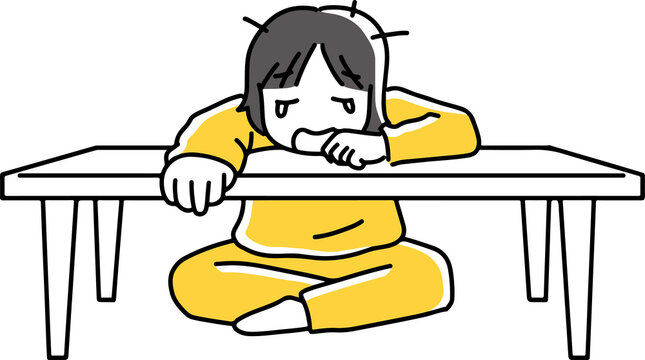机に伏して泣く女性