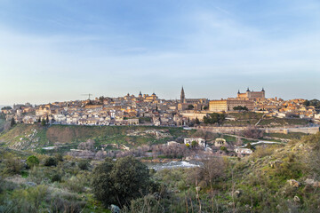 Naklejka premium Toledo city skyline across the Tagus river, Spain, high angle view. Medieval architecture in soft late afternoon light