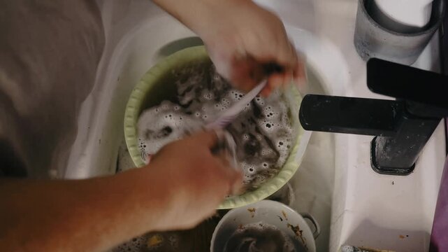 The guy washes dishes every day. 