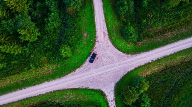 Top-down view of a car at a rural road intersection