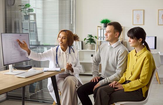 Couple and doctor consultation about fertility planning. Physician explains results at a healthcare appointment with advice on pregnancy and tests. Clinic appointment and family fertility concept.
