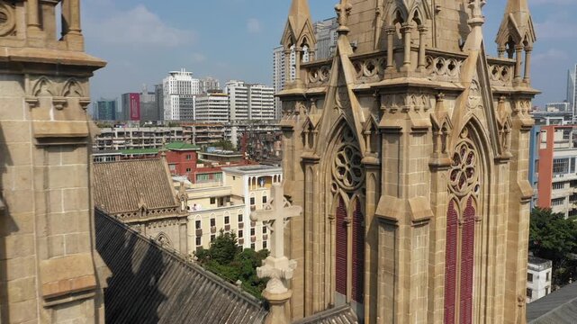 Flying past granite Sacred Heart Cathedral reveals residential and commercial buildings in Guangzhou, China