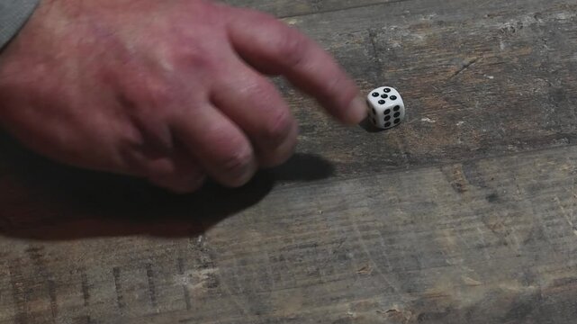 throw dice on a wooden table 5-5