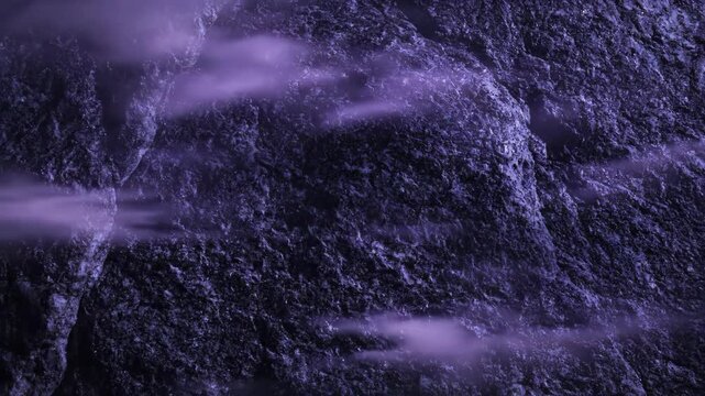 Close-up texture of dark purple rough stone surface displaying granular details and deep shadows with a dramatic and mysterious atmosphere