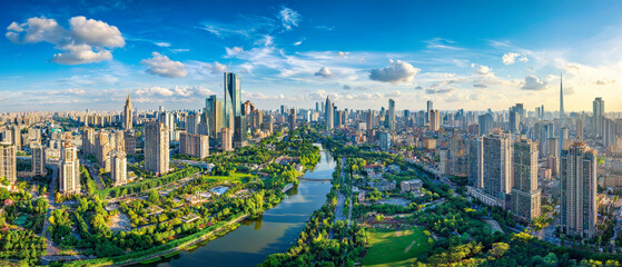 Naklejka premium People walk and recreate in parks by the river in an Asian city filled with tall buildings under a bright blue sky. The sun shines on the urban landscape