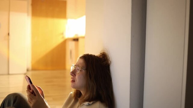 Young woman reacts to phone content late evening emotional overload frustration from endless scrolling draining energy quiet home space and lost control of attention