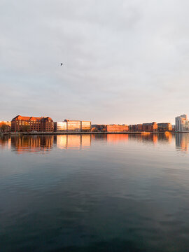 Peaceful sunset reflection on Copenhagen canal water, calm evening atmosphere in the Danish capital