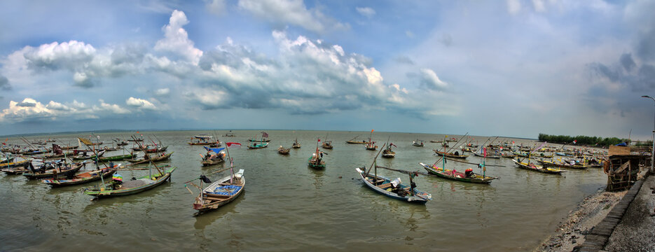 Numerous fishing junks along the coast. Boats of fishing cooperatives and individual fishermen. Village waiting for the fishing season. Indonesia