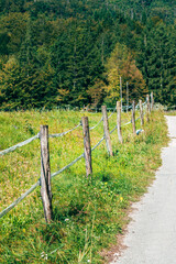 Fototapeta premium Timber clad barrier in Slovenian countryside, rustic wooden farm structure in alpine rural landscape.