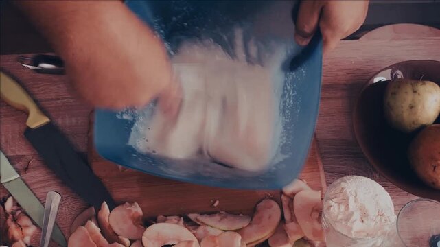 a man cuts the dough with a knife to make a homemade apple pie and