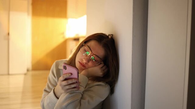 Woman leaning on wall looking directly into camera while holding smartphone urging to stop wasting time on endless content consumption and return to real life presence and meaningful daily actions