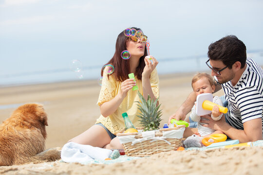 couple with little baby on beach