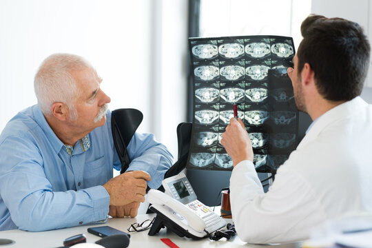 doctor with patient looking at x-ray results