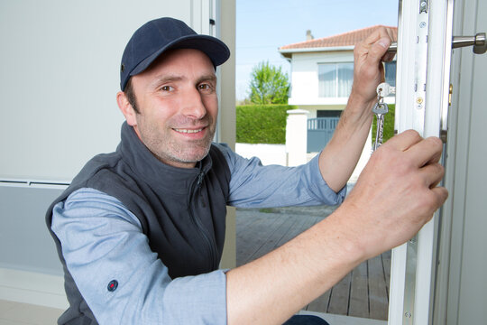 portrait of locksmith working at residential property