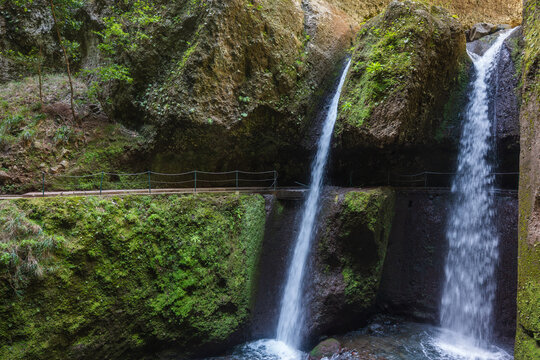 Twin waterfall and levada path in Madeira laurel forest gorge