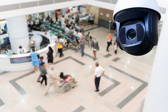 CCTV Security Camera Monitoring Hospital Lobby with Blurred Crowd