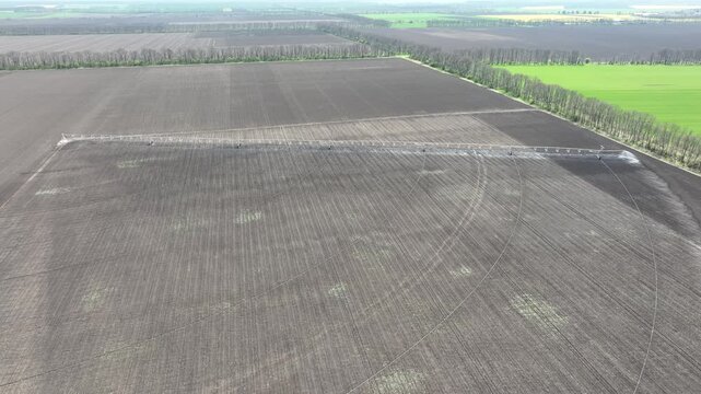 Aerial View of Pivot Irrigation System Watering Fertile Farmland. Modern Agriculture Technology for Sustainable Crop Growth and Soil Hydration