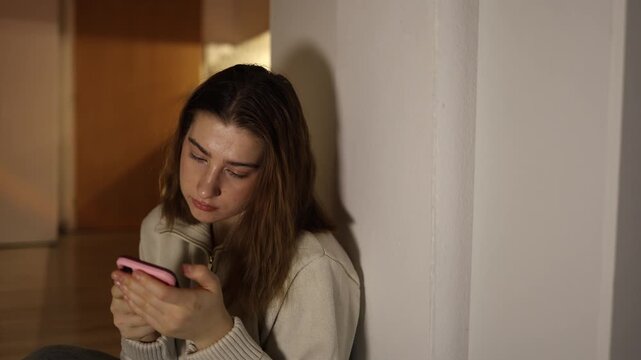 Woman scrolling smartphone instead of doing home tasks late evening digital habit social media content distraction procrastination low productivity routine home life