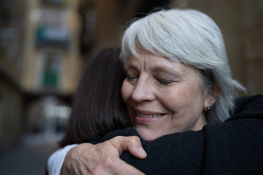 Two women embracing each other tightly, showing genuine affection and unwavering support in their friendship.