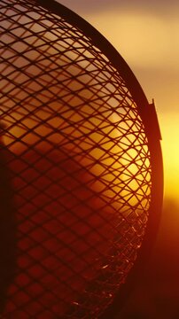 Fan spinning at sunset in slow motion